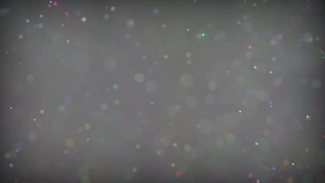Defocused shimmering multicolored glitter confetti, black background. Party, magic, imagination. Rainbow colors, sparkle circles. Holiday abstract festive texture of shiny blurred bokeh light spots.