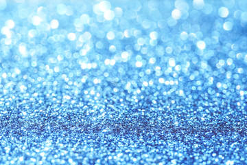 Fototapeta premium blue Sparkling Lights Festive background with texture. Abstract Christmas twinkled bright bokeh defocused and Falling stars. Winter Card or invitation
