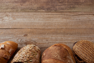 fresh baked loaves of delicious bread on wooden rustic table
