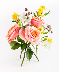 Beautiful bunch with coral roses with green leaves on white background