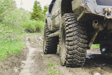 Fototapeta premium Dirty cars and wheels in the mountains. Swamp on the tires. Trips offroad across Ukraine. View of the Carpathian Mountains.