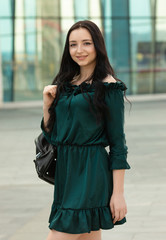 Young female brunette walking in the park.