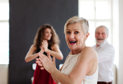 Senior Couple In Dancing Class With Dance Teacher.