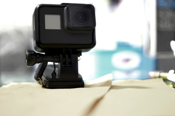 Action camera in mount stand clipping clamp on table