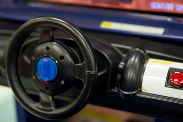 Obraz premium car steering of console of racer game machine in game arcade