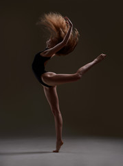 Ballerina with long hair jumping 