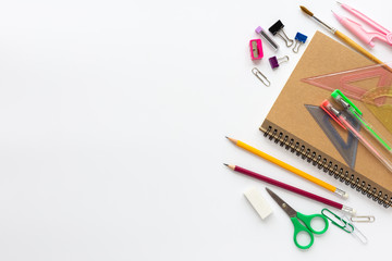 Top view of school supplies on a white background