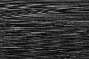 Texture of black crushed eyeliner or black acrylic paint