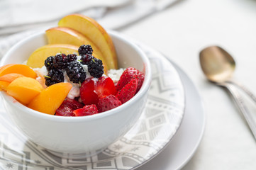 Sliced strawberry, apricot, apple and mulberry with cottage cheese and sour cream