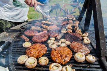 Man preparing BBQ at outdoor party