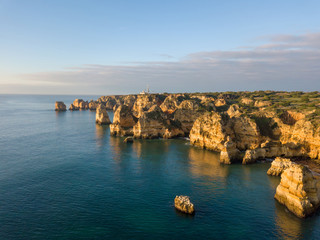 Algarve aerial drone panoramic view. Amazing landscape at sunrise. Beautiful beach near Lagos, Algarve region, Portugal.  Seascape with cliff rocks.