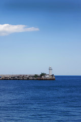 Coastal landscape. Lighthouse on horizon. Summer vacation