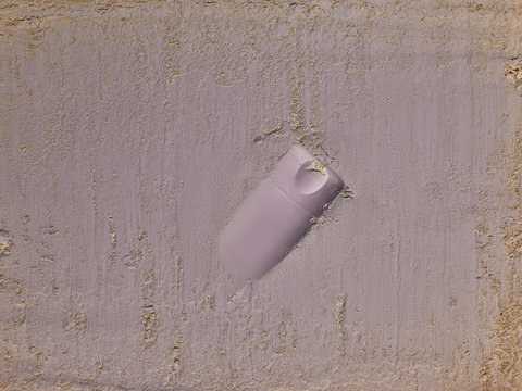 recyclable Plastic cosmetic bottle or tube sunk in ground, pastel colours