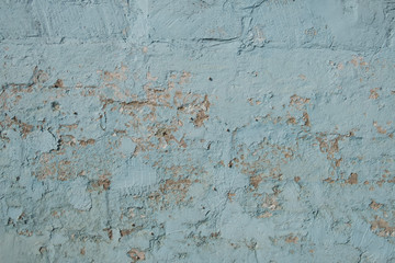 Background old brick wall. Brick wall in blue paint. Texture of damaged paint on the wall.