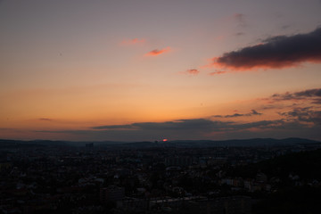 Colorful sunset on Bila Hora with beautiful view on city Brno, Czech Republic pink and orange colors with many clouds