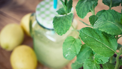 Homemade lemonade with mint, ice, and fresh lemon slices in mason jar