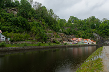 Panoramic landscape view on river Vltava in the historic city of Cesky Krumlov with famous Church city is on a UNESCO World Heritage Site captured during spring with nice sky and clouds