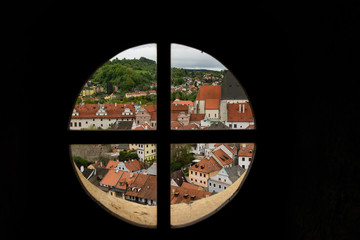 View through the window on the tower of the castle and the view of Cesky Krumlov with the famous Cesky Krumlov Castle, the Church of the World Heritage Site