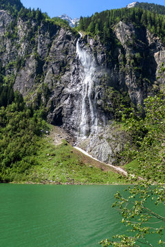 Waterfall flows over granite roocks in the mountains, Stillup Lake,  Austria, Tyrol, Zillertal