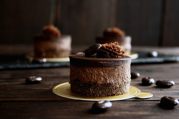 Mini chocolate cakes on wooden background
