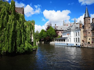 Bruges canals with church, castle and trees