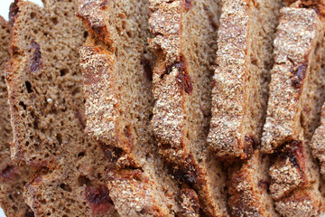 Pieces of homemade rye bread with cranberries isolated on white background. The view from the top.