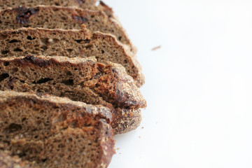 Pieces of homemade rye bread with cranberries isolated on white background.