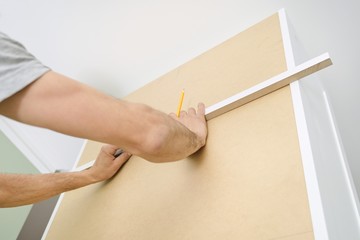 Closeup of furniture assembly with professional tools.