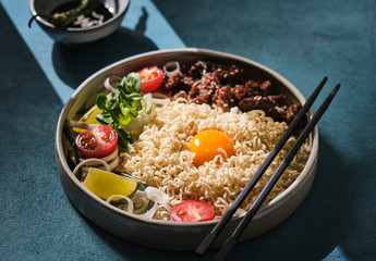 Chinese noodles with beef, vegetables and eggs. Asian cuisine. Ramen with meat. Traditional Chinese food