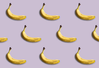 Bananas pattern isolated on purple background. Summer fruit.