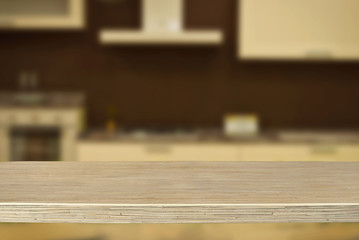 A wooden board on the background of the kitchen. An empty product board. Sharpness in the foreground. Empty space for goods.