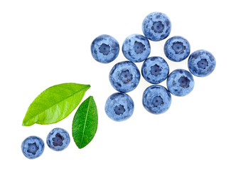 Blueberries with leaves on a white background, top view.
