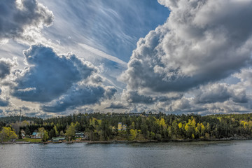 Fototapeta na wymiar Amazing spring landscape with incredible cloudscape over Stockholm archipelago.