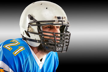 Concept american football, portrait of american football player in helmet with patriotic look. Black white background, copy space.