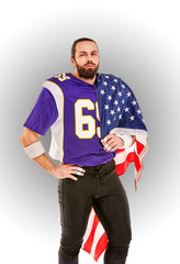 American football player closeup portrait. American football player with an american flag in his hands. Concept patriotism, celebration.