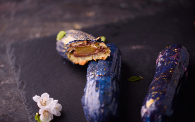 Beautiful and tasty dessert on a slate board with petals.