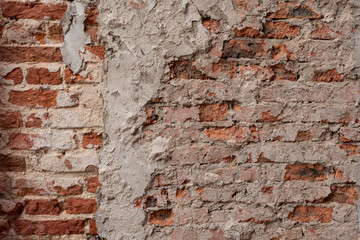Old vintage dirty brick wall with peeling plaster, background, texture close up. Shabby building facade with damaged plaster. Abstract web banner. Copy Space.