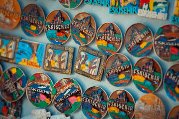 group of handmade colorful magnet souvenirs at marketplace