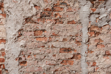 Empty old brick wall texture. Grungy wide brickwall. Red stonewall background. Building facade with damaged plaster. Abstract web banner. Copy Space.