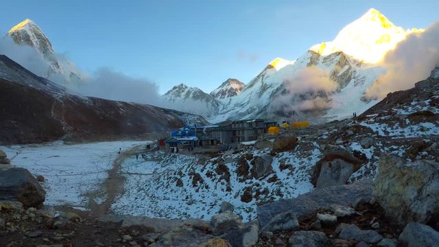 4k time lapse view of Gorak Shep village at the foot of mountains Pumori, Nuptse and Everest at sunset in Sagarmatha National Park in Nepal. Travel, adventure, hiking and climbing concept.