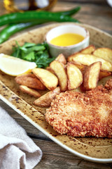 Tasty schnitzel with boiled potato. Top view, flat lay food