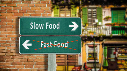Obraz premium Street Sign Slow versus Fast Food