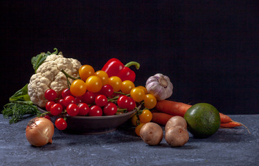 Composition of vegetables on dark cement background. Black background with copy space. Organic food. Organic farming concept. 