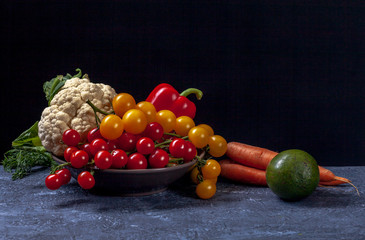 Composition of vegetables on dark cement background. Black background with copy space. Organic food. Organic farming concept. 