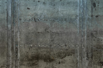 grunge background: rough concrete wall with cracks and dents, traces of formwork
