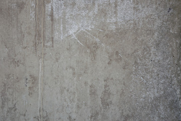 grunge background: rough concrete wall with cracks and dents, traces of formwork