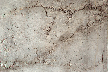 grunge background: rough concrete wall with cracks and dents, traces of formwork