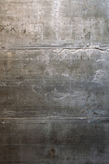 grunge background: rough concrete wall with cracks and dents, traces of formwork