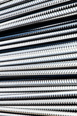 bright iron grunge background: glittering new clean reinforcement bars, short focus