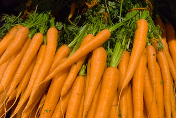 closeup of a stack of orange carrots in the supermarket